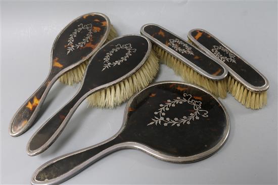 A Mappin & Webb five-piece silver pique and tortoiseshell-mounted dressing table set,